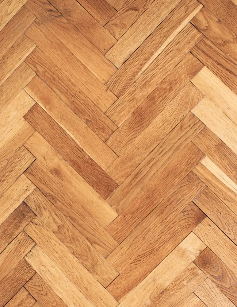 Herringbone wood flooring in a warm tone